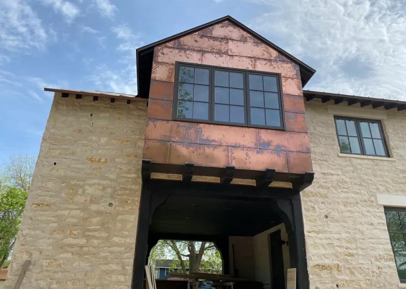 Copper metal panel facade on a stone building for Skylight Installation in Lander